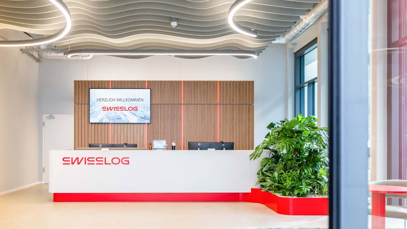 Swisslog headquarters building in Buchs, Switzerland with the new Swisslog logo