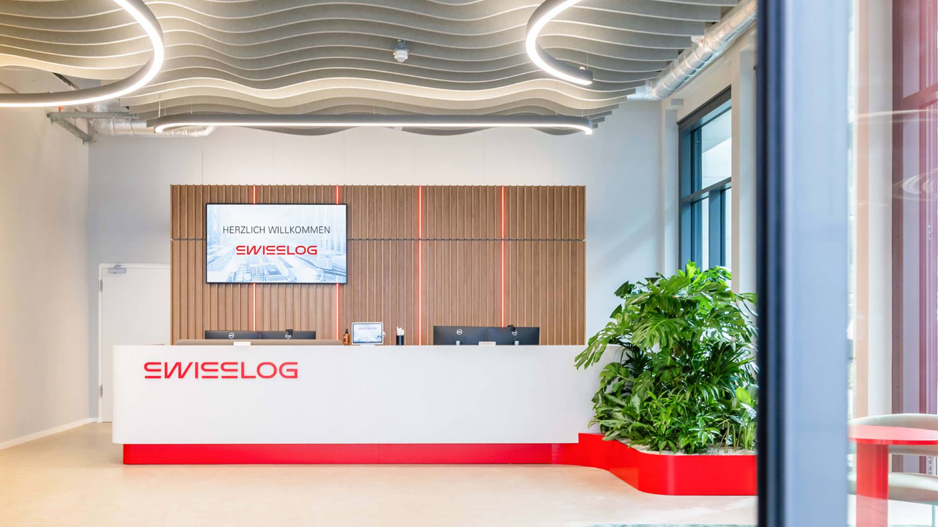 Swisslog headquarters building in Buchs, Switzerland with the new Swisslog logo
