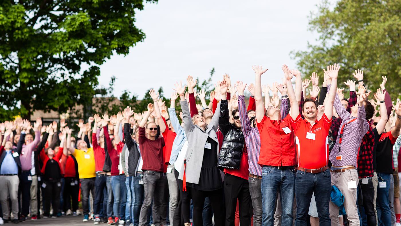 Swisslog colleagues cheering at staff summer event