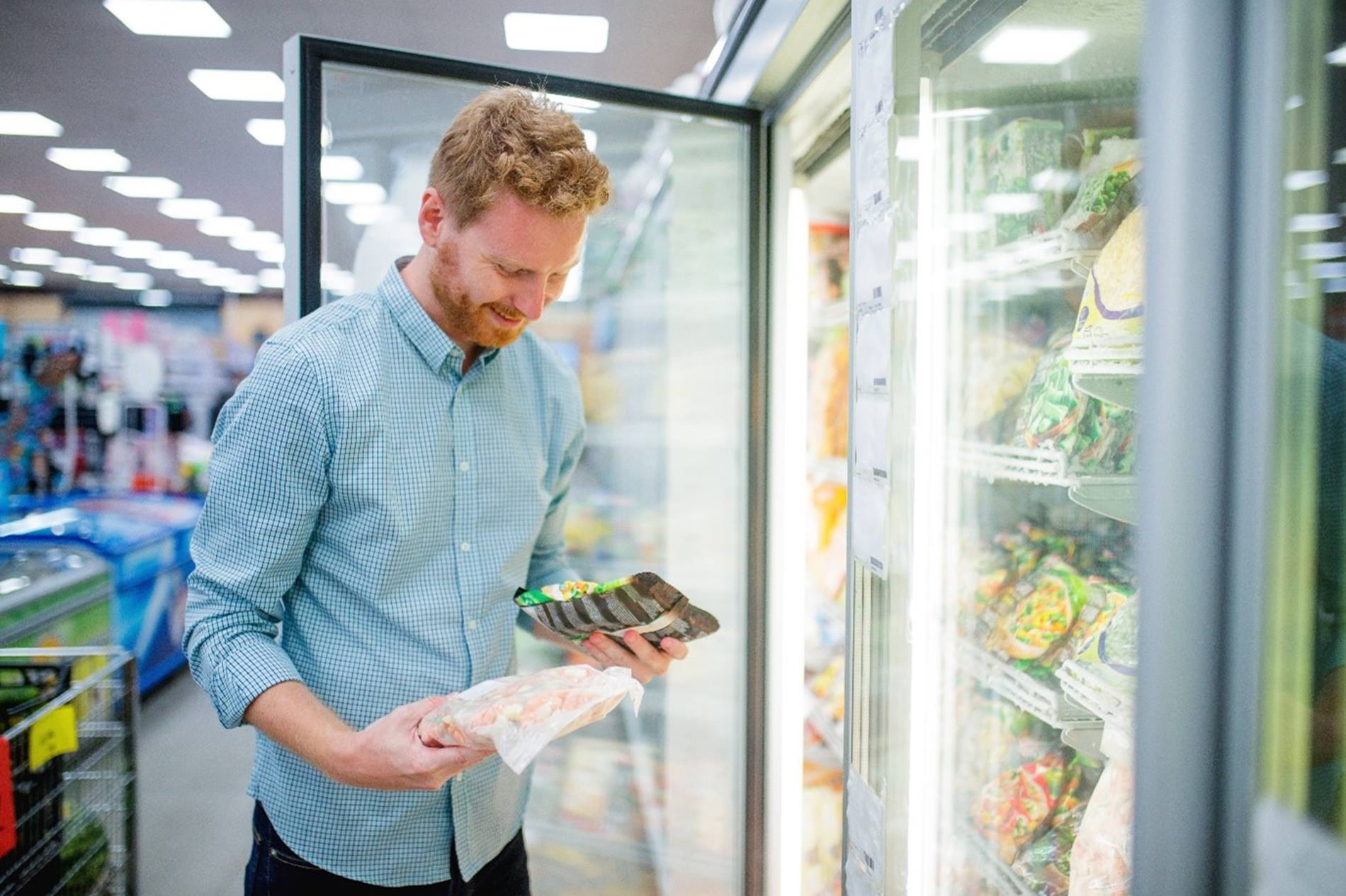 Consumer looking at frozen food produce