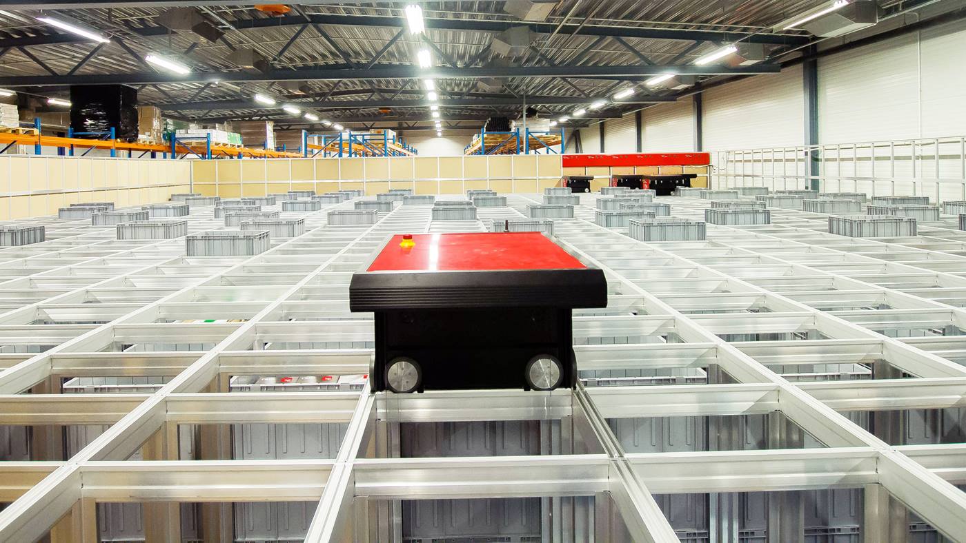Swisslog AutoStore robots store and retrieve smaller SKUs in high density storage 