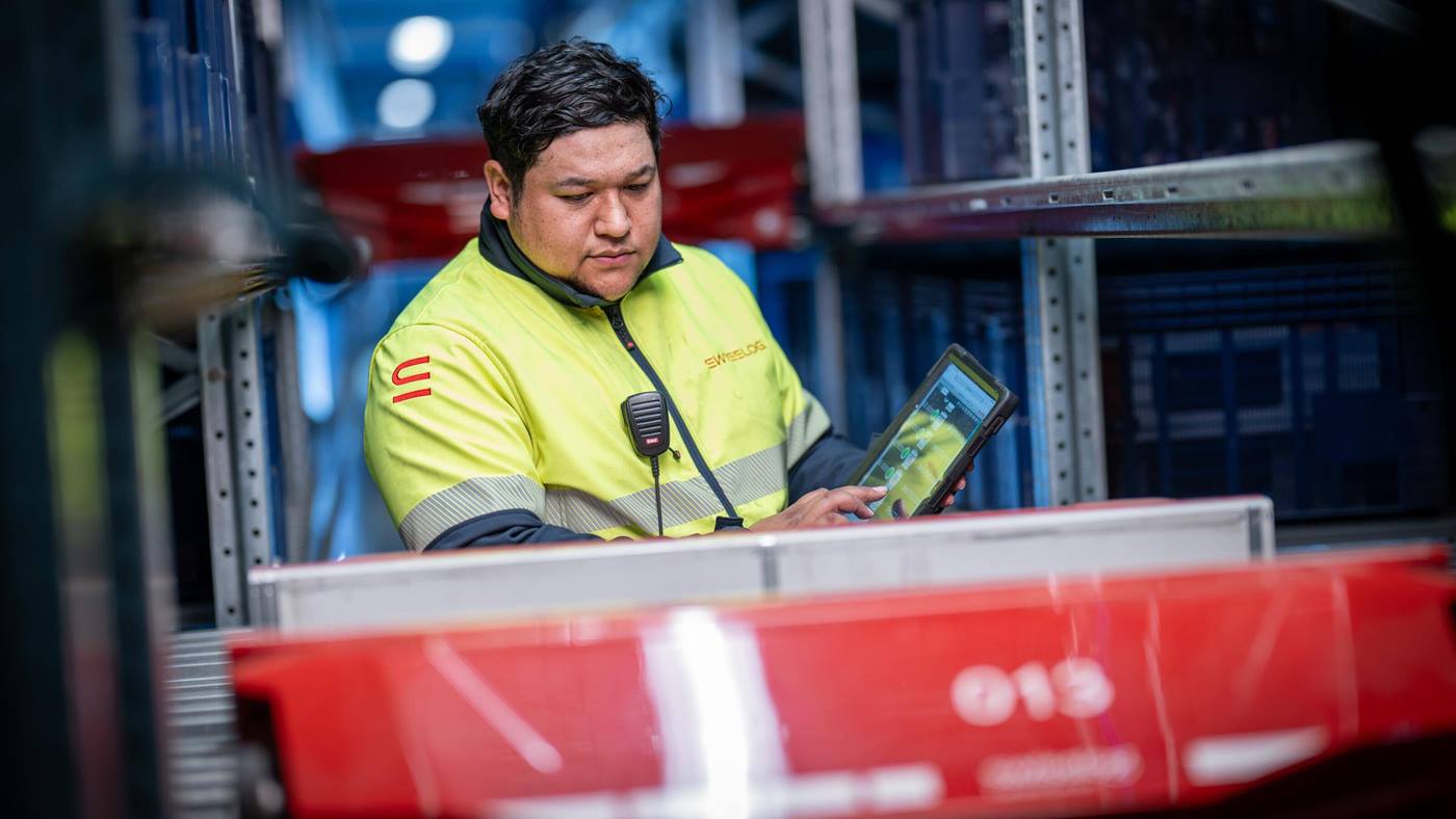 Swisslog engineer checking a CycloneCarrier shuttle at Jaycar site in Sydney Australia