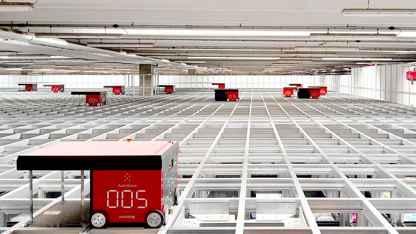 Red Swisslog AutoStore robots on a grid
