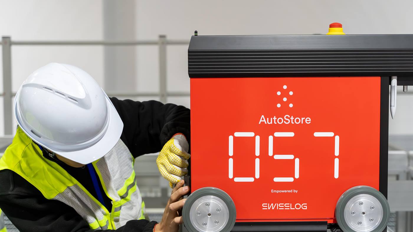 Swisslog service engineer working on an AutoStore robot