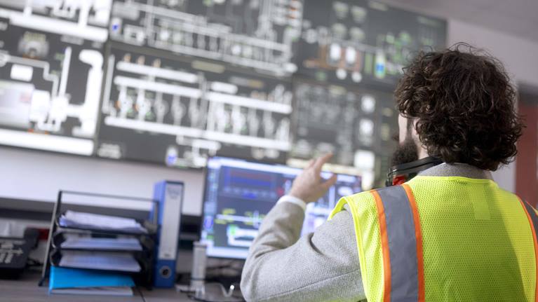 Warehouse engineer looking at warehouse management systems